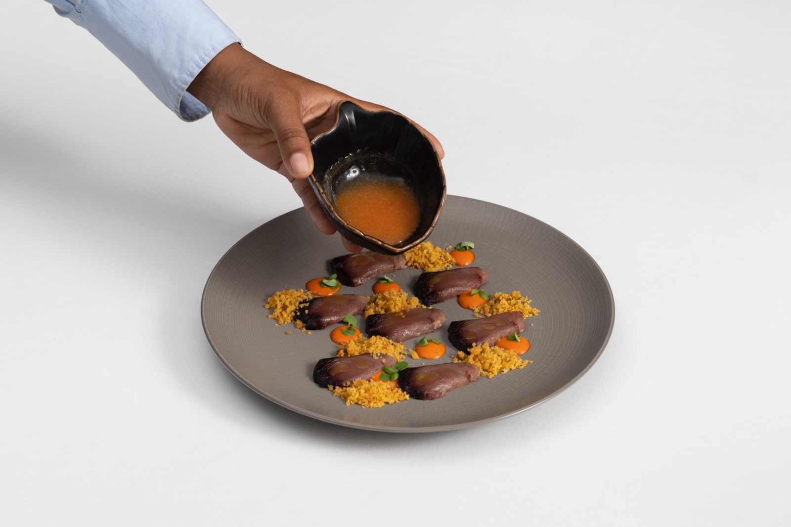 A dish being finished at Restaurante Tágide