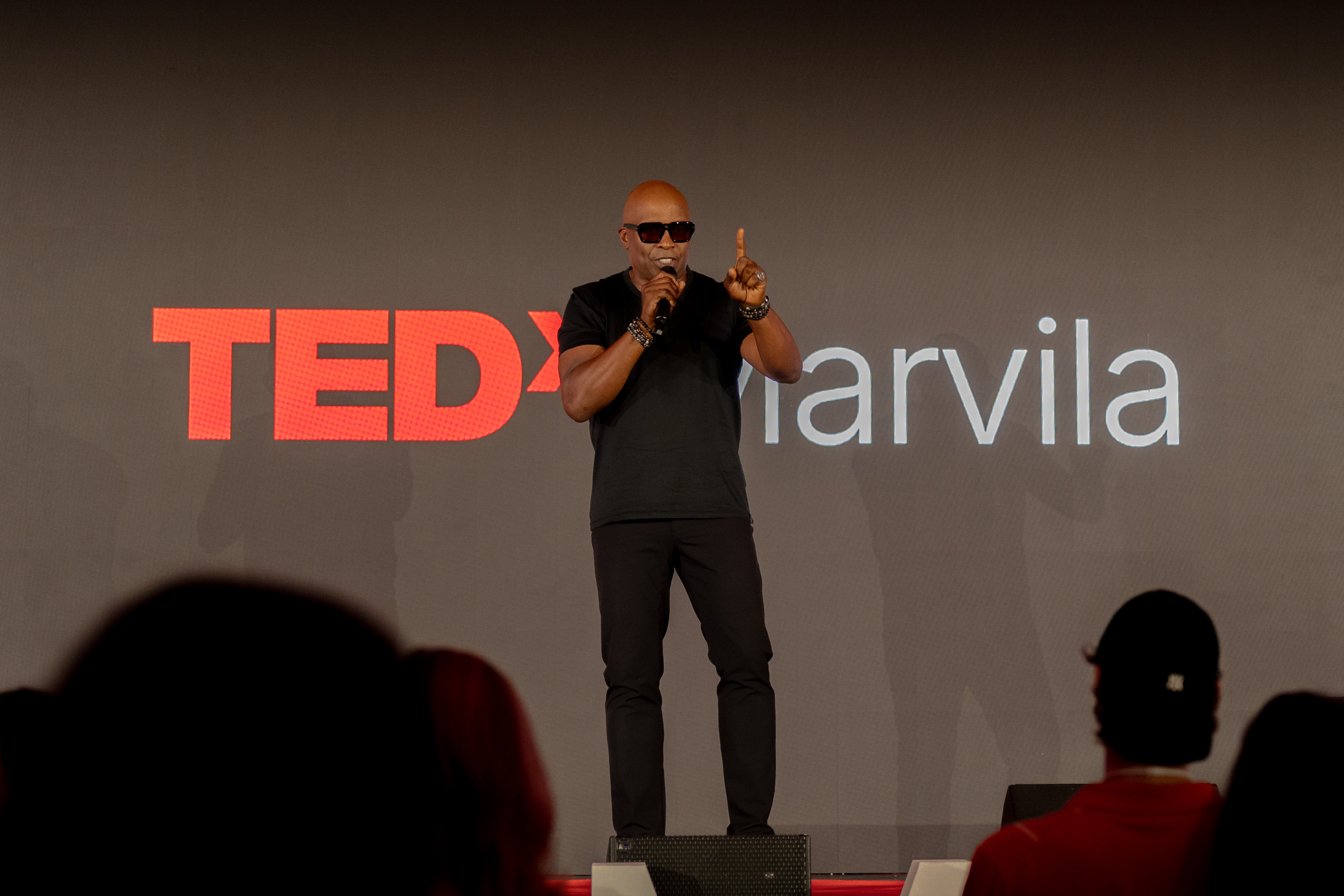 A speaker on stage at TEDx Marvila